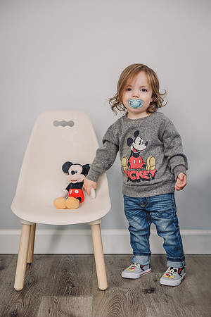 little boy with his mickey mouse shirt and toy