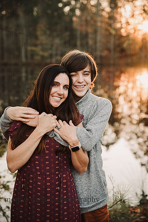teen boy poses with his mom at sunset
