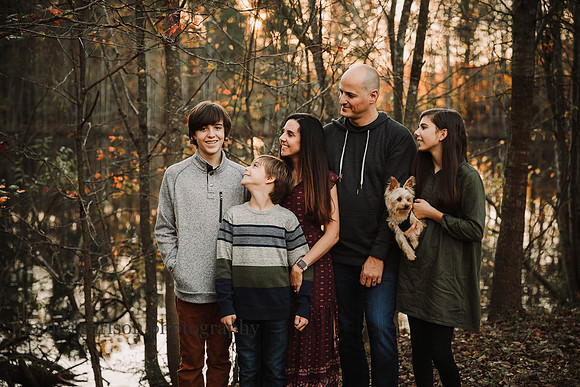 family of five in front of a golden lake