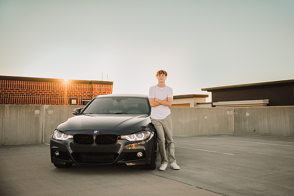 car and young man on the roof top of a parking lot at halcyon