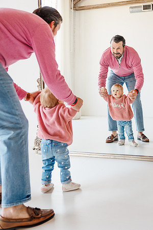 daddy and daughter look at themselves in a large mirror