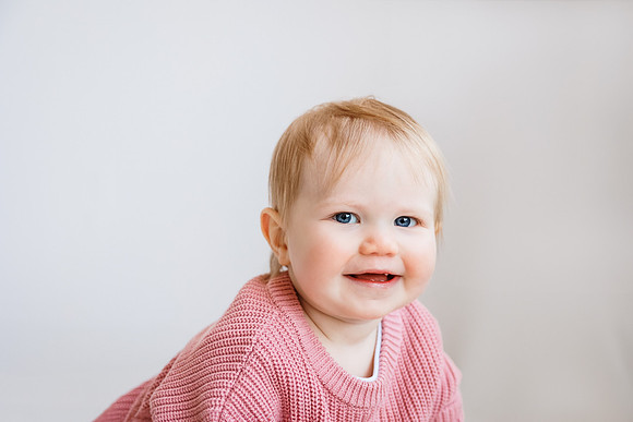 portrait of a smiling one year old girl