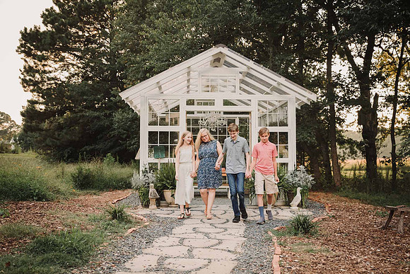 mom with her teen kids walk away from a greenhouse at Prospect farms