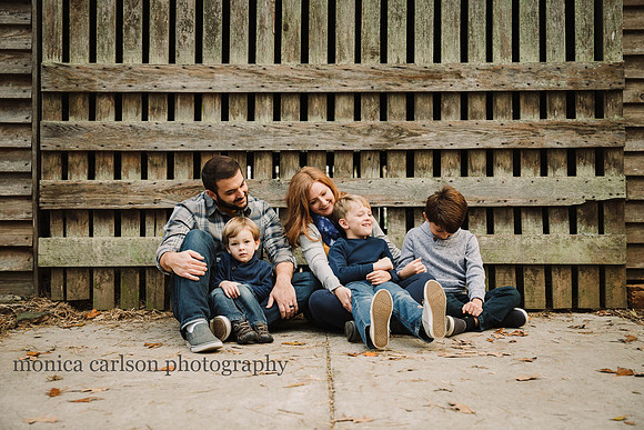 family poses during a family photo session at a barn in the McDaniel Family Farm with Monica carlson Photography