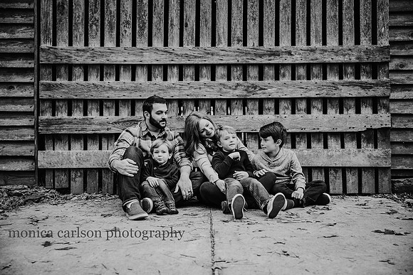 family of five sit in front of a barn in Duluth, GA