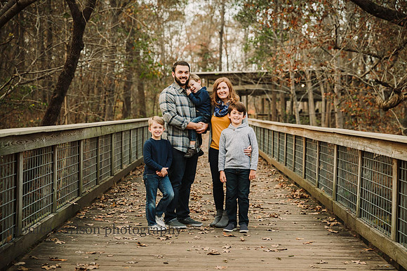 Family of five on a bridge at Mcfarland family farm