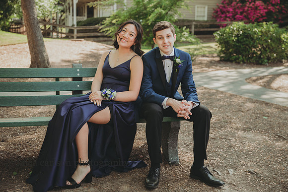 seated portrait of a young couple before they attened their first prom by monica carlson