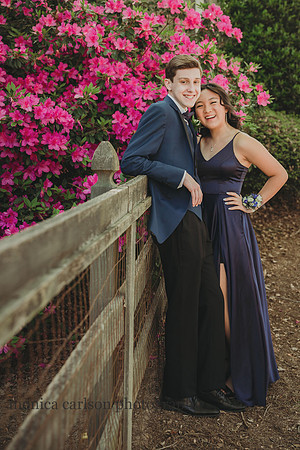 Happy tetn couple pose together in front of azeleas by monica carlson photography