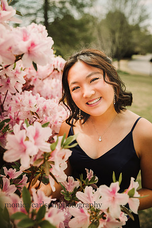 Teen girl standing near azeleas before her prom at Lambert High school in suwanee, Georgia