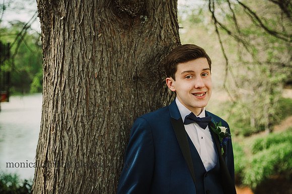 teenager in a tuxedo smiling before prom by monica carlson photography