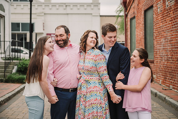 adirable family of five portrait on the streets of marietta square by monica carlson