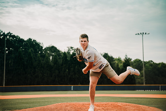 Teen boy throwing a baseball at Pope High School