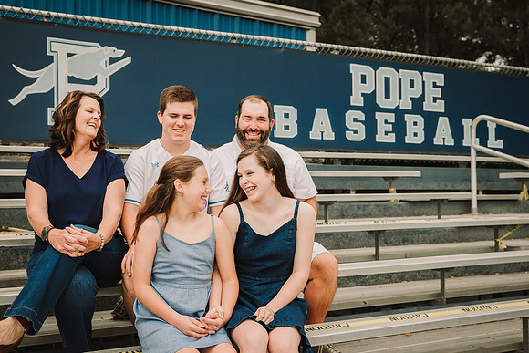 family laughing together in the baseball stadium at pope High school