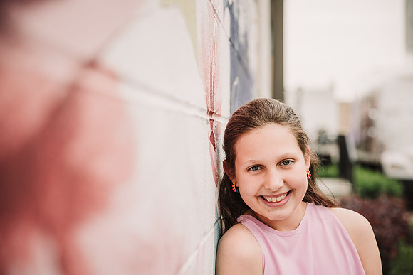 portrait of a tween along a mural in marietta