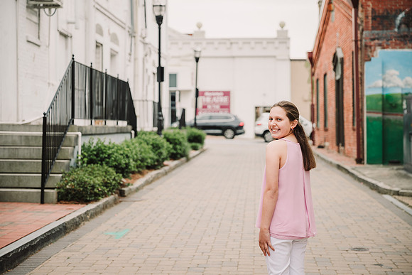 tween looking over her shoulder on a brick street in Marietta, GA
