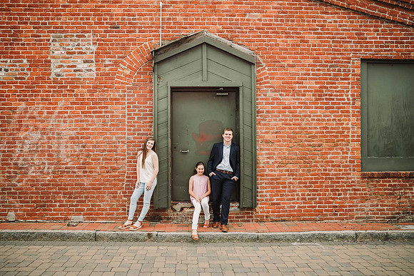 siblings standing in a doorway in a brick building in Marietta square
