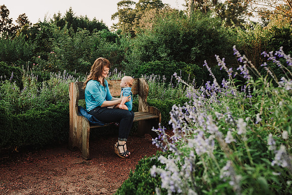Mother smiling at her baby boy in the garden at Barrington Hall