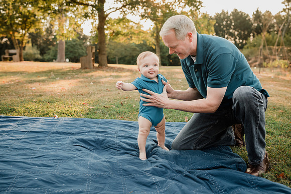 daddy holding his infant son up at Barrington Hall