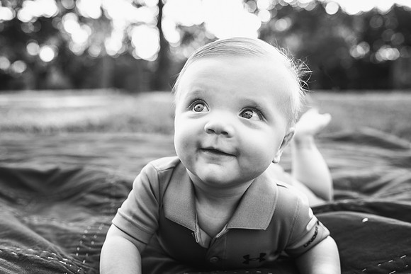 black and white portrait of a baby look up sweetly