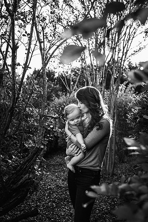 Mother kissing her baby son on the head during a family photography session