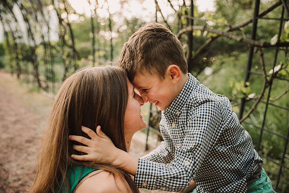 young boy shares eskimo kisses with his mother during a photo session