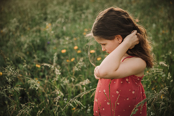 curly, brow haired girl on a wildflower field  at prospect farms