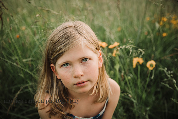 portrait of a blonde girl on a flower field by monica carlson photography