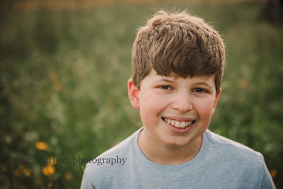 portrait of a smiling teen boy on a flower field at Prospect Farms