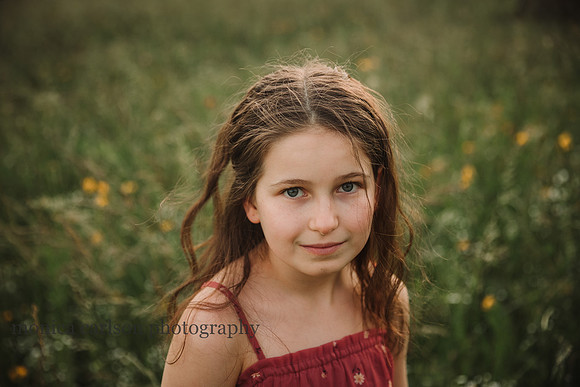 curly haired girl looks at the camera on Prospect farms