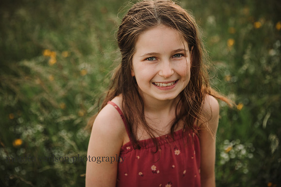 girl laughs while standing on a wildflower field at Prospect Farms