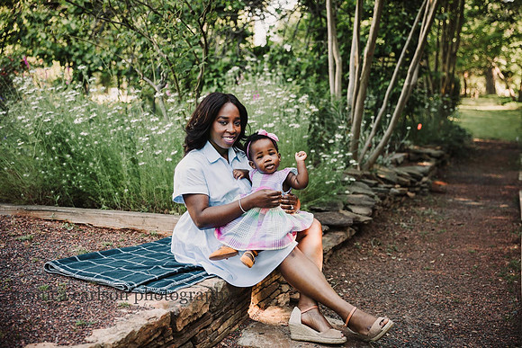 african american mother and cild sit in a garden in roswell by monica carlson