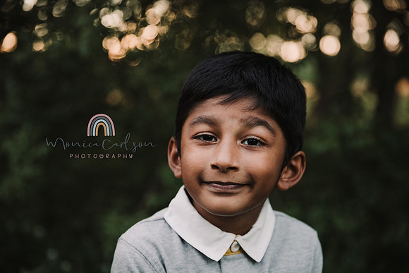 elementary aged boy smirks for the camera at sunset