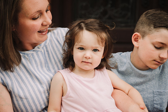 portrait of a little girl sitting on her mothers lap