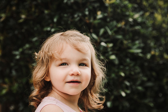 portrait of a happy blonde toddler girl