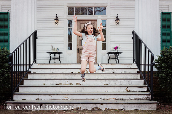 Girl jumping from steps of a Historic home in Roswell by Monica carlson