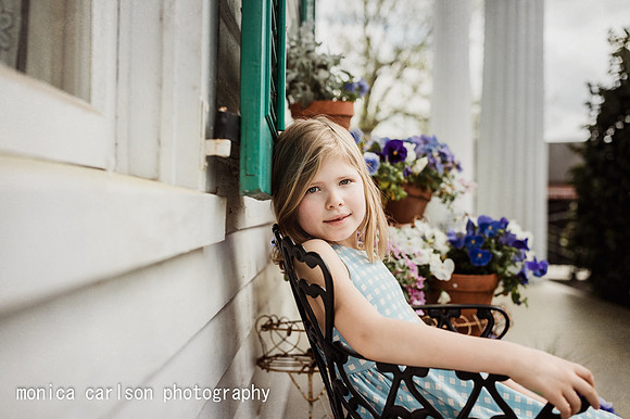 Young girl sitting on a chair on the patio of a historic home in Roswell, GA