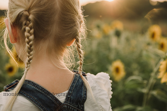 detailed shot of a little blonde girls braids at sunset