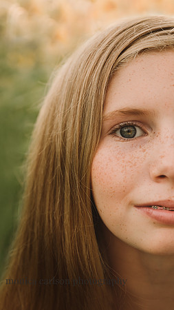 upclose image of a red headed freckled face girl