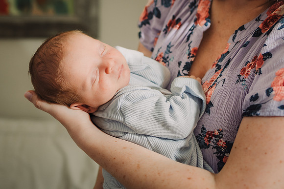 mom holds newborn baby boy