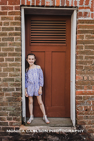 tween girl standing in front of a red door at Barrington Hall