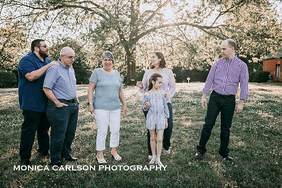 Causal photo of a extended family laughing together by monica carlson photography