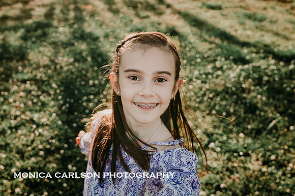 portrait of a brunette girl at sunset that has braces