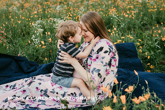 mother ad her son share a tender moment in a wildflower field