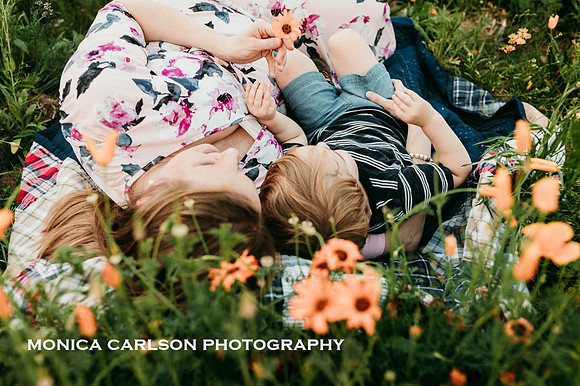 mother and son cuddling in a field of flowers in Lawernceville, GA