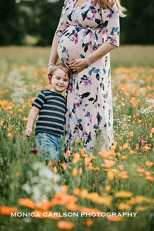 pregnant mother with her son in a wildflower field