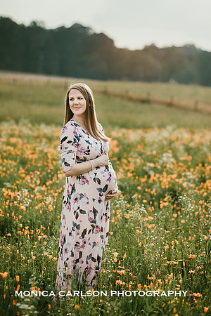 pregnant woman standing in a wildflower field at Prospect Farms