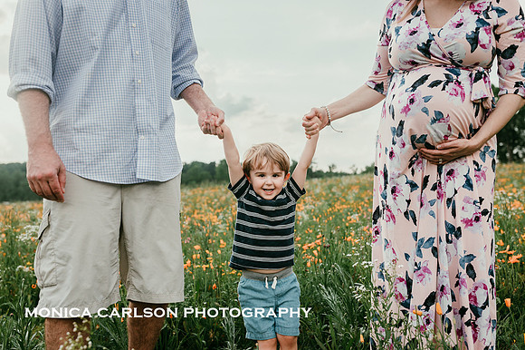 man and woman swinging their toddler son during a family photo session