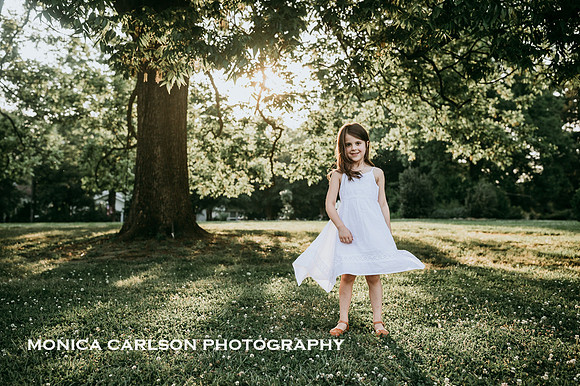 back lit image of a girl spinning on the grounds of barrington hall by monica carlson