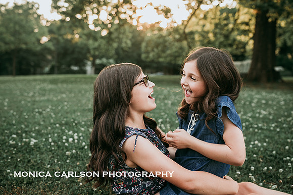 sisters laughing together by monica carlson photography