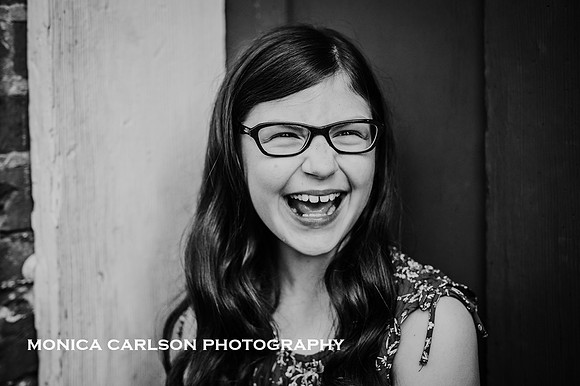 black and white portrait of a laughing tween
